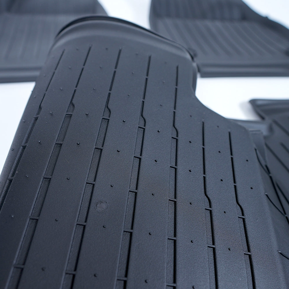 The back is structured with grips to keep it in place. | All-Weather Floor Mats for Model Y